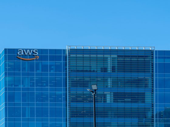 WS office building with the AWS logo on a glass skyscraper against a clear blue sky