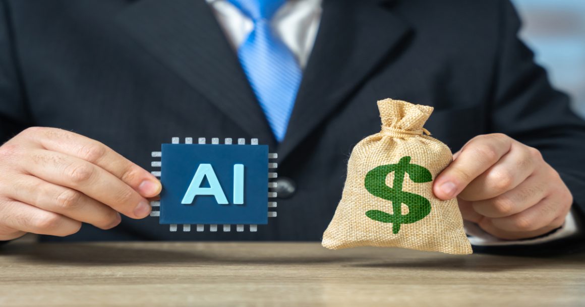A businessman in a suit holds an AI microchip and a money bag with a dollar sign, representing investment and financial returns in artificial intelligence.