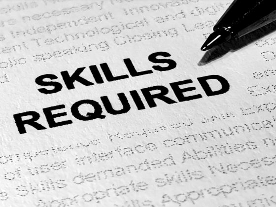 "Skills required" printed on a job description, illustrating skills-based hiring over degree requirements.